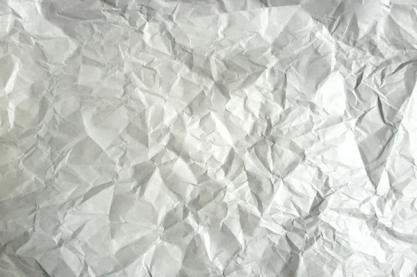 A crumpled sheet of heavy paper