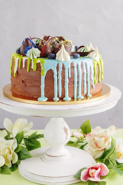 Chocolate cake with fruit and blue glaze