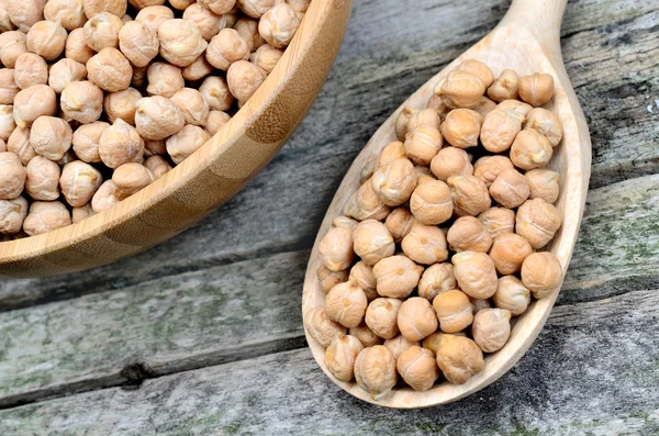 Chick peas in wooden spoon