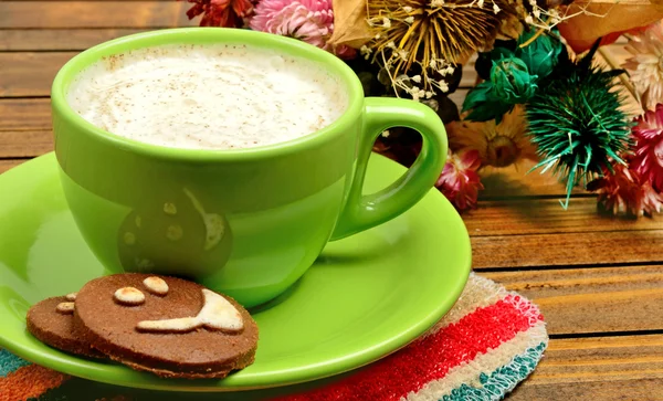 Cup of cappuccino with cocoa biscuits
