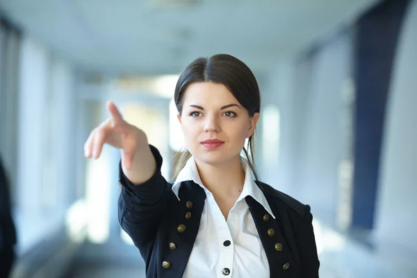 Businesswoman points with finger
