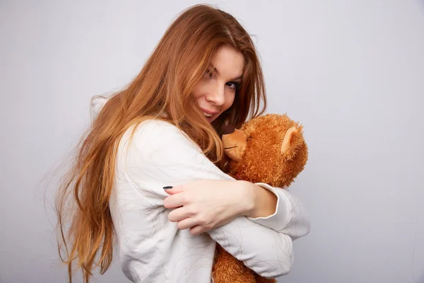 Red-haired woman with teddy bear