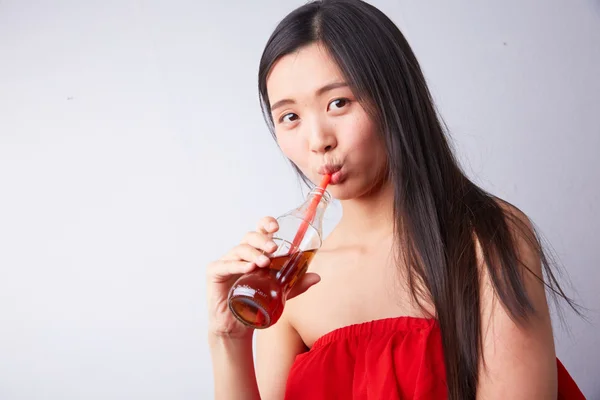Chinese woman drinking carbonated drink