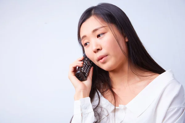 Sad Chinese woman with phone