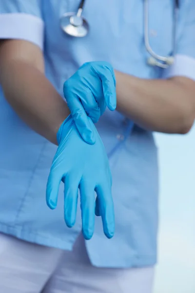 Doctor wearing medical gloves