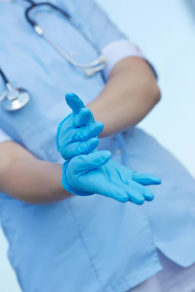 Doctor wears medical gloves