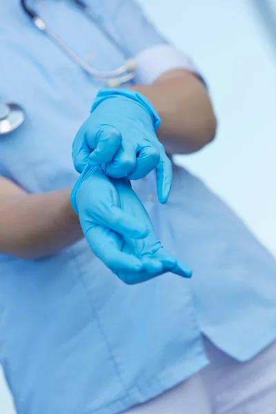 Doctor wears medical gloves