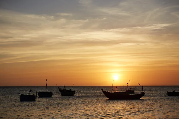 Fishing boats at sunset