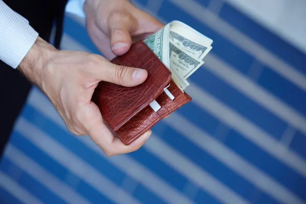 Man holding purse with money