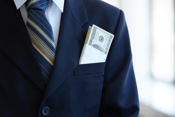 From his pocket a businessman sticking out of money