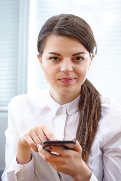 Business woman with mobile mobile in office