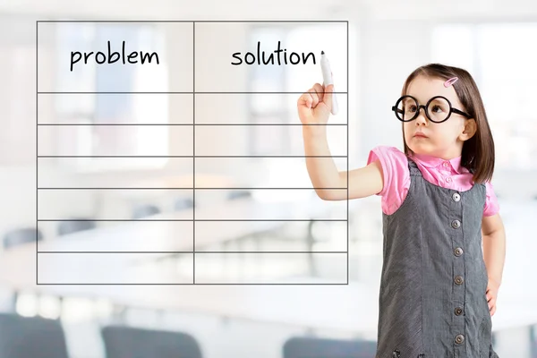 Cute little girl wearing business dress and writing problem and solution list in blank. Office background.