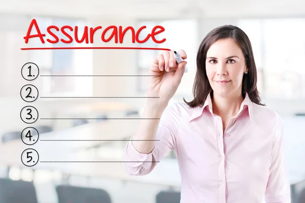 Business woman writing blank Assurance list. Office background.