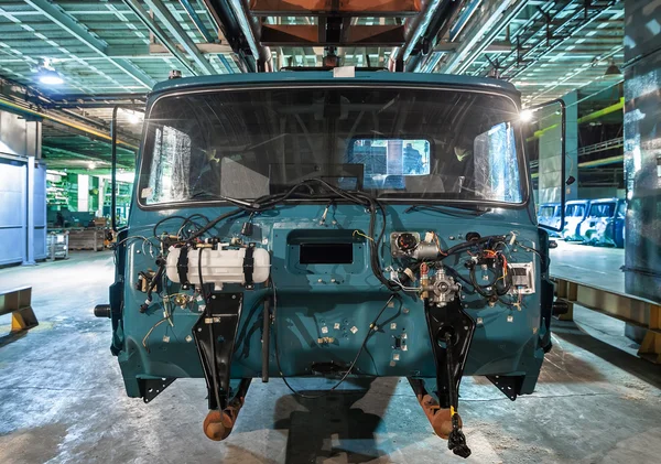 Bankrupt and abandoned automobile plant. The frame of the cab car on the production line.