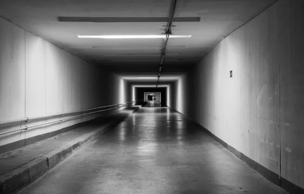 Empty dark tunnel at night. Monochrome