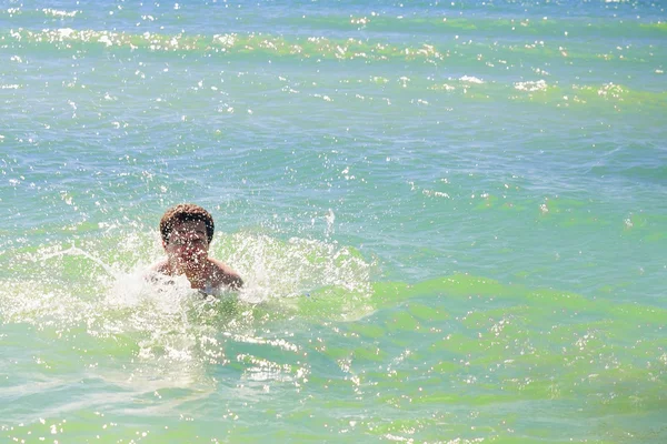 Swimming man ocean water