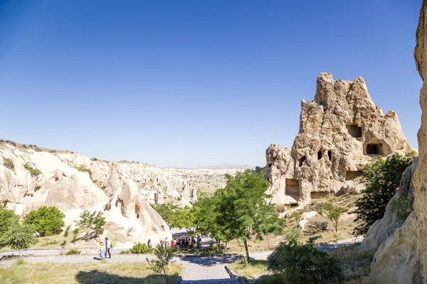 CAPPADOCIA, TURKEY - JUN 25, 2014: Photo of tourists visiting the cave monastery complex at the Open Air Museum of Goreme