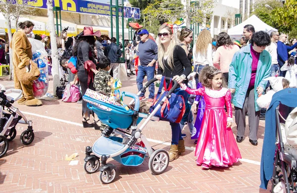 Beer-Sheva, ISRAEL - March 5, 2015: Children and parents with prams at spring street -Purim