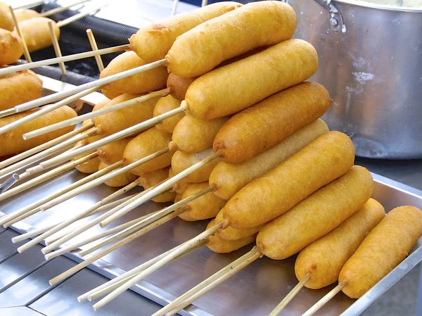 Closeup of corn dogs for sale in market