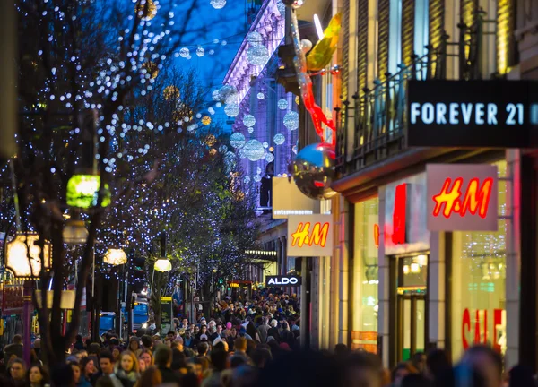 Christmas lights decoration at Oxford street and lots of people walking during the Christmas sale, London