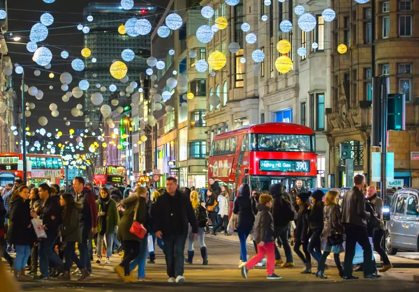 Christmas lights decoration at Oxford street and lots of people walking during the Christmas sale, London