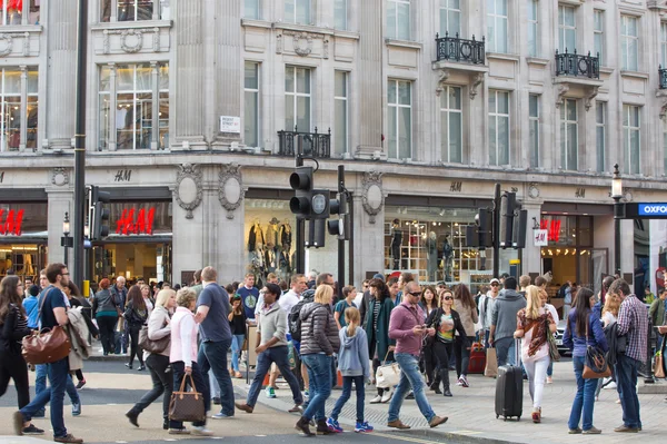 Regent street with lots of walking people crossing the road. London