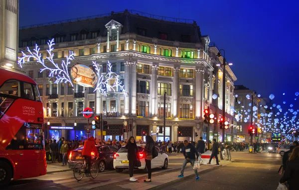 LONDON, UK - NOVEMBER 30, 2014: Black Friday weekend in London the first sale before Christmas. Regent street beautifully decorated with Christmas lights. Roads were open for pedestrians only