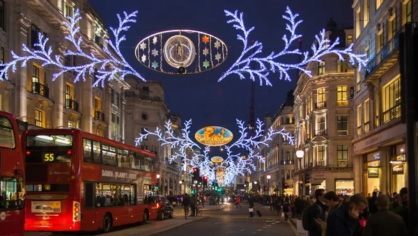 LONDON, UK - NOVEMBER 30, 2014: Black Friday weekend in London the first sale before Christmas. Regent street beautifully decorated with Christmas lights. Roads were open for pedestrians only