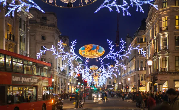 LONDON, UK - NOVEMBER 30, 2014: Black Friday weekend in London the first sale before Christmas. Regent street beautifully decorated with Christmas lights. Roads were open for pedestrians only