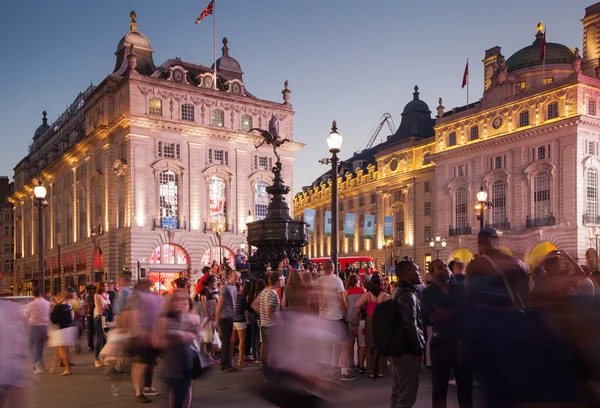 LONDON, UK - AUGUST 22, 2014: Piccadilly Circus in night. Famous place for romantic dates. Square was built in 1819 to join of Regent Street