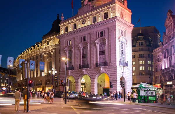 LONDON, UK - AUGUST 22, 2014: Piccadilly Circus in night. Famous place for romantic dates. Square was built in 1819 to join of Regent Street