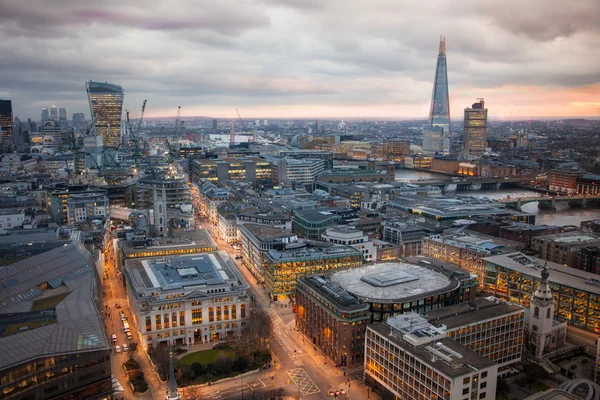 LONDON, UK - JANUARY 27, 2015: Busy streets of City of London in the dusk. First evening lights and sunset. London\'s panorama from the St. Paul cathedral