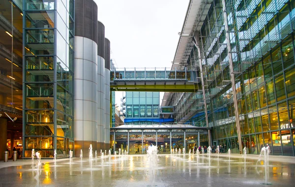 LONDON, UK -  MARCH 28, 2015: Heathrow airport Terminal 5 new square with fountains and wet reflected floor.