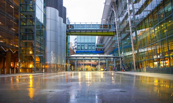 LONDON, UK -  MARCH 28, 2015: Heathrow airport Terminal 5 new square with fountains and wet reflected floor.