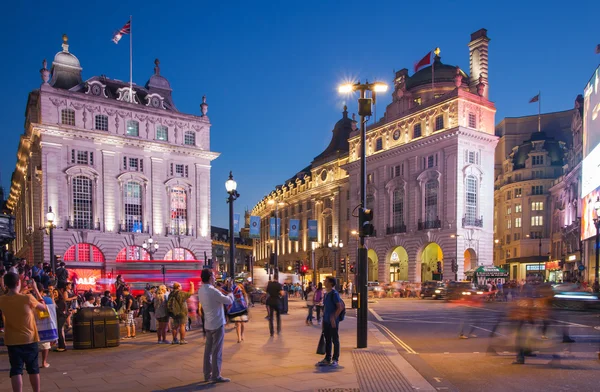 LONDON, UK - AUGUST 22, 2014: Piccadilly Circus in night. Famous place for romantic dates. Square was built in 1819 to join of Regent Street