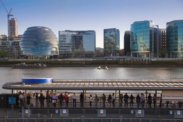 LONDON, UK - APRIL15, 2015: Modern buildings on the south bank of river Thames walk. Office centre, theatre and  London city hall building in sun set