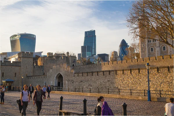 LONDON, UK - APRIL15, 2015: Walkie Talkie building and Tower of London. River Thames side walk.