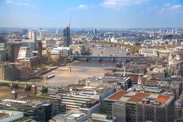 LONDON, UK - APRIL 22, 2015: City of London panorama includes river Thames, bridges, London eye and St. Paul\'s cathedral