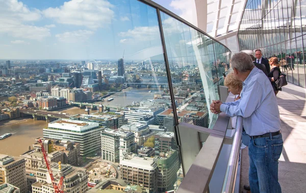 LONDON, UK - APRIL 22, 2015: People looking at the London's skyline. Viewing platform of Walkie-Talkie building. Locates on 32 floor and offering amazing view of the city.