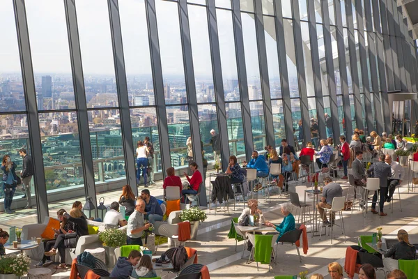 LONDON, UK - APRIL 22, 2015: People in the restaurant of the Sky Garden Walkie-Talkie building. Viewing platform is heist UK garden, locates at the 32 floor and offers amazing skyline of London city.