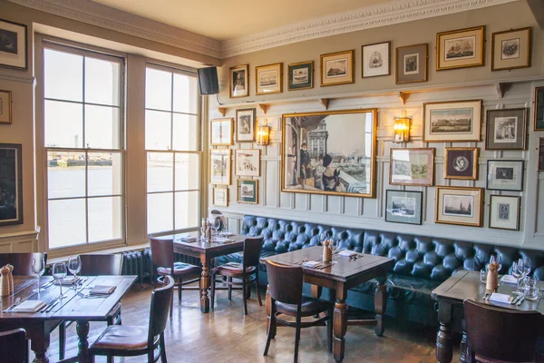 LONDON, UK - APRIL 14, 2015: Old English victorian public house interior. Early morning settings with no people
