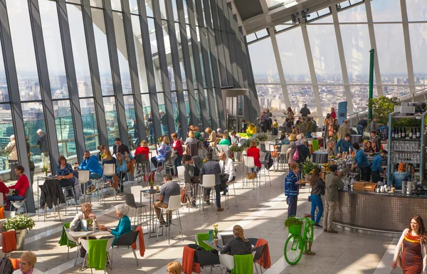 LONDON, UK - APRIL 22, 2015: People in the restaurant of the Sky Garden Walkie-Talkie building. Viewing platform is highest UK garden, locates at the 32 floor and offers amazing skyline of London city