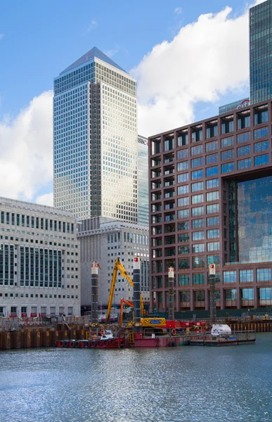 LONDON, UK - MARCH 31, 2015: Canary Wharf building site with cranes and digger. New resident skyscraper going to be raised next to Canary Wharf business development