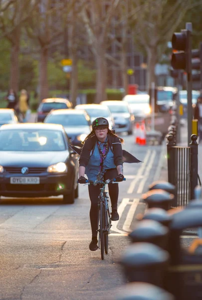 LONDON, UK - 7 SEPTEMBER, 2015: Londoners commuting from work by bike. Road view with cars and cyclers