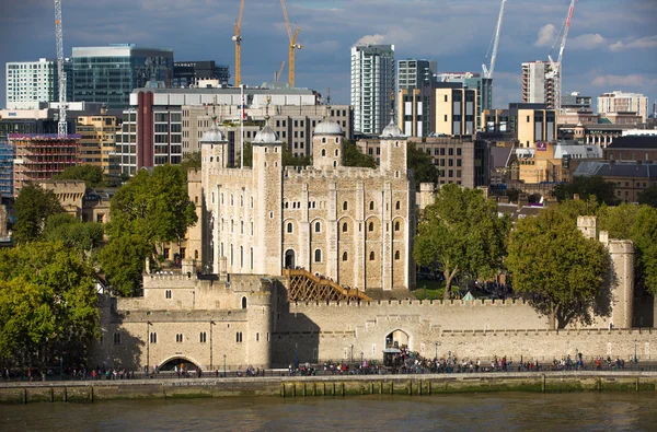 LONDON UK - SEPTEMBER 19, 2015 - Tower of London, River Thames and people walking by embankment