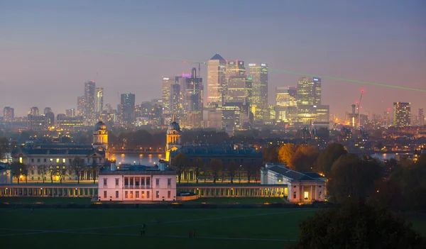 London,Panorama of Canary Wharf in night. View includes the park, Royal chapel, Painted hall and green light of Greenwich zero tome meridian