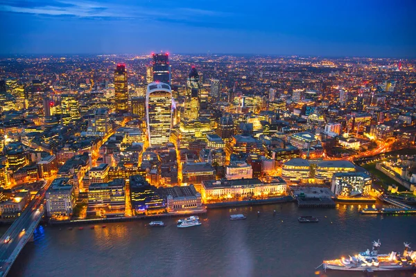 LONDON, UK - APRIL 15, 2015: City of London night view and well lit up streets aerial view