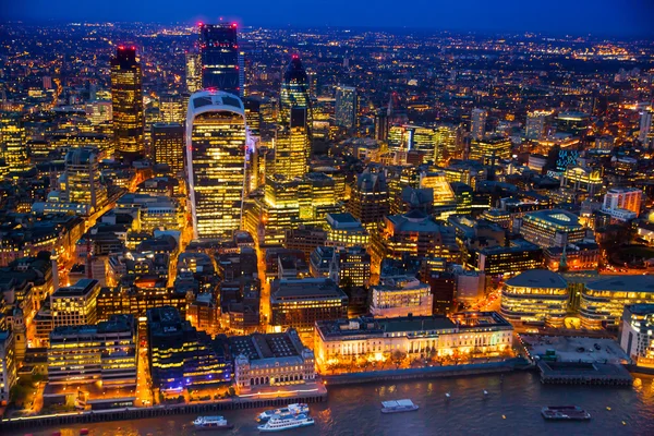 LONDON, UK - APRIL 15, 2015: City of London night view and well lit up streets aerial view