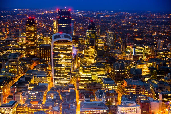 LONDON, UK - APRIL 15, 2015: City of London night view and well lit up streets aerial view