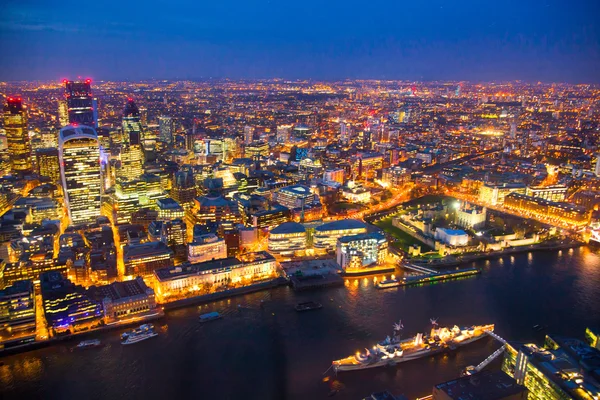 LONDON, UK - APRIL 15, 2015: City of London night view and well lit up streets aerial view